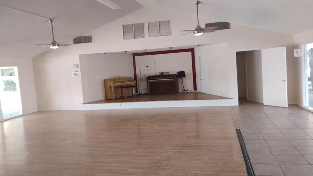 a room with furniture pool table and windows