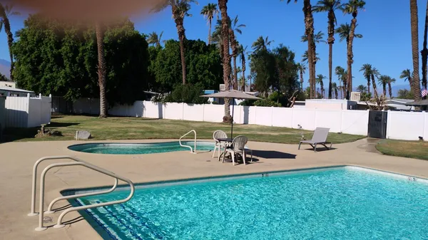 a room with furniture pool table and windows