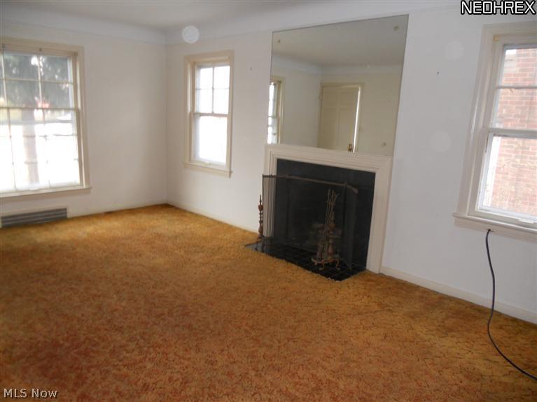13690 Cedar Road Cleveland, OH 44118 - Photo 11 of 12 First floor living room with fireplace and hardwood under carpeting.