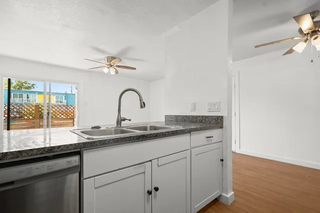 a bathroom with a granite countertop sink mirror and vanity
