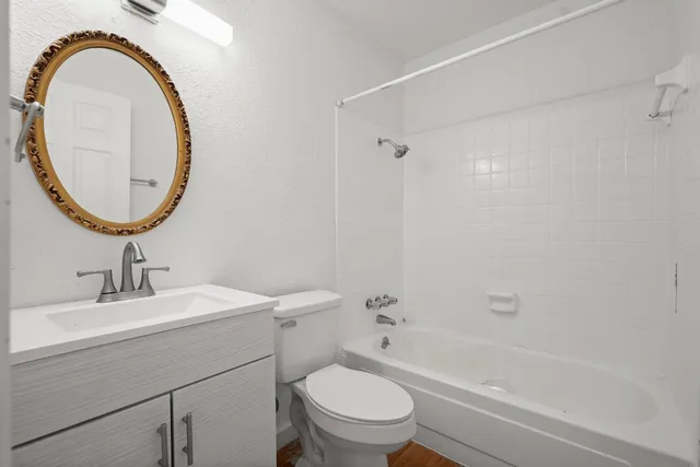 an empty room with a ceiling fan and a fan