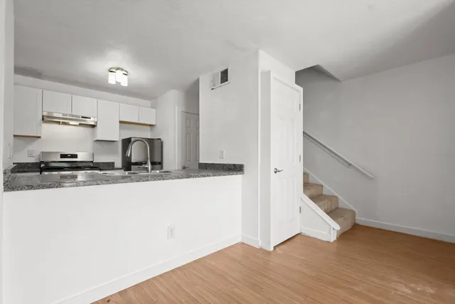 a view of a ceiling fan and wooden floor