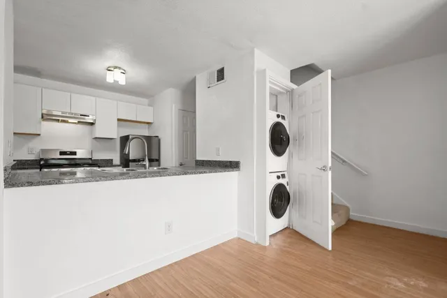 a kitchen with stainless steel appliances a sink and a refrigerator