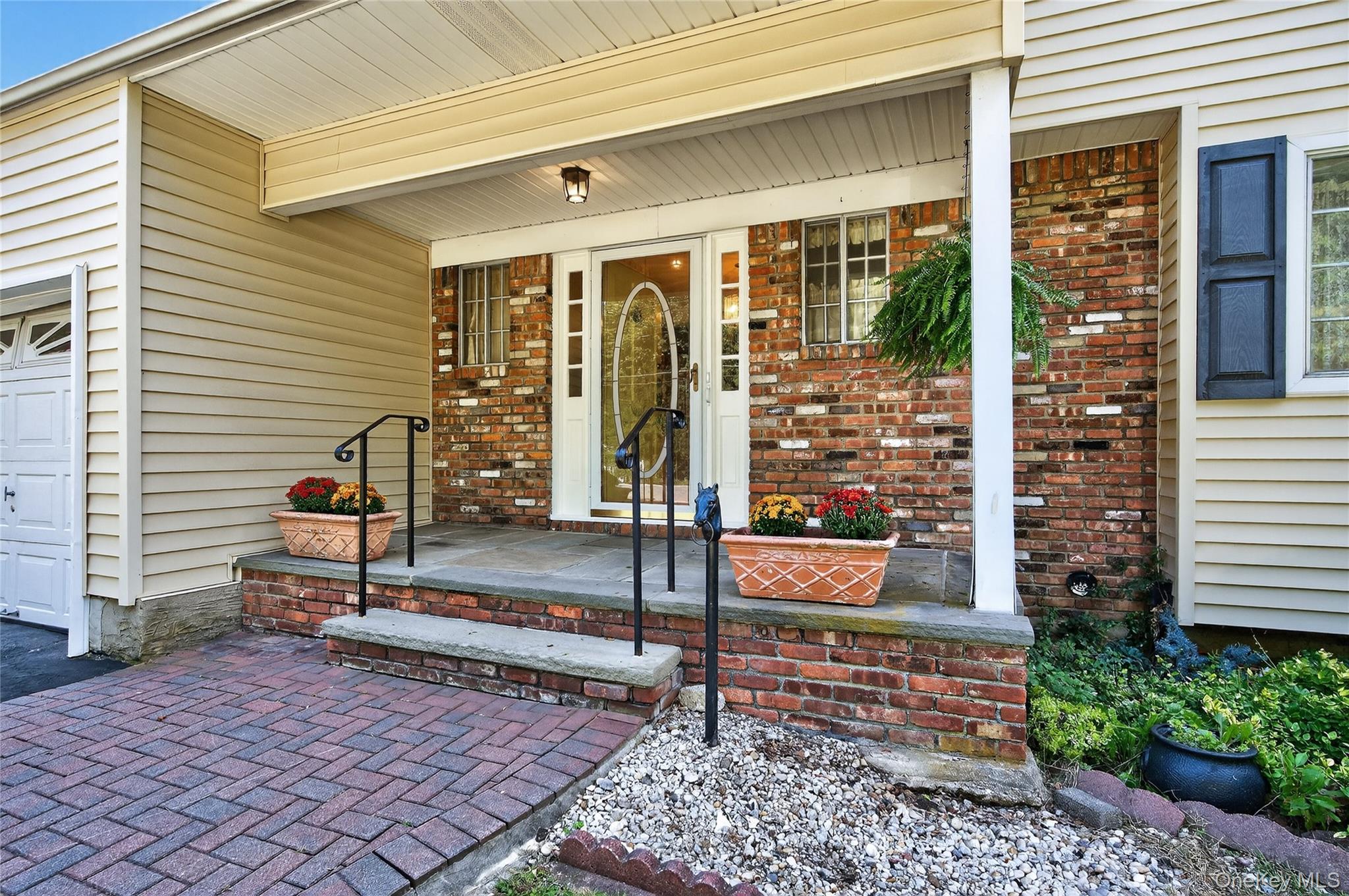 88 Ayers Road Locust Valley, NY 11560 - Photo 1 of 1 Doorway to property with a porch and brick siding