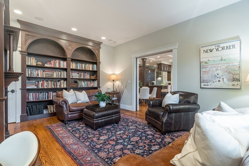 91 University Road, Unit 1 Brookline, MA 02445 - Photo 12 of 39 a living room with furniture hard wood floor and a book shelf