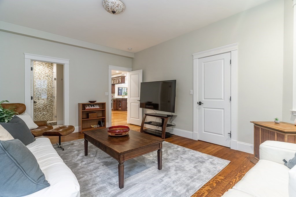 91 University Road, Unit 1 Brookline, MA 02445 - Photo 14 of 39 a living room with furniture and a flat screen tv