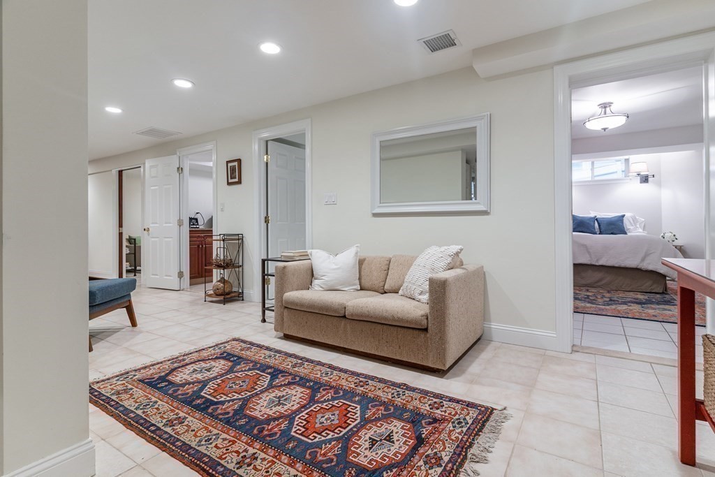 91 University Road, Unit 1 Brookline, MA 02445 - Photo 21 of 39 a living room with furniture and a rug