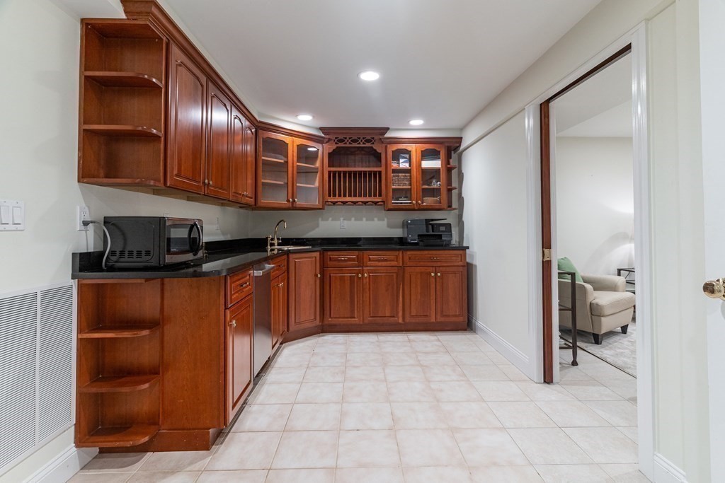 91 University Road, Unit 1 Brookline, MA 02445 - Photo 23 of 39 a kitchen with stainless steel appliances granite countertop a sink and cabinets