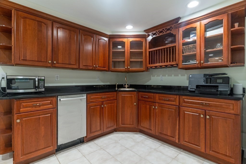 91 University Road, Unit 1 Brookline, MA 02445 - Photo 24 of 39 a kitchen with stainless steel appliances granite countertop a sink and cabinets