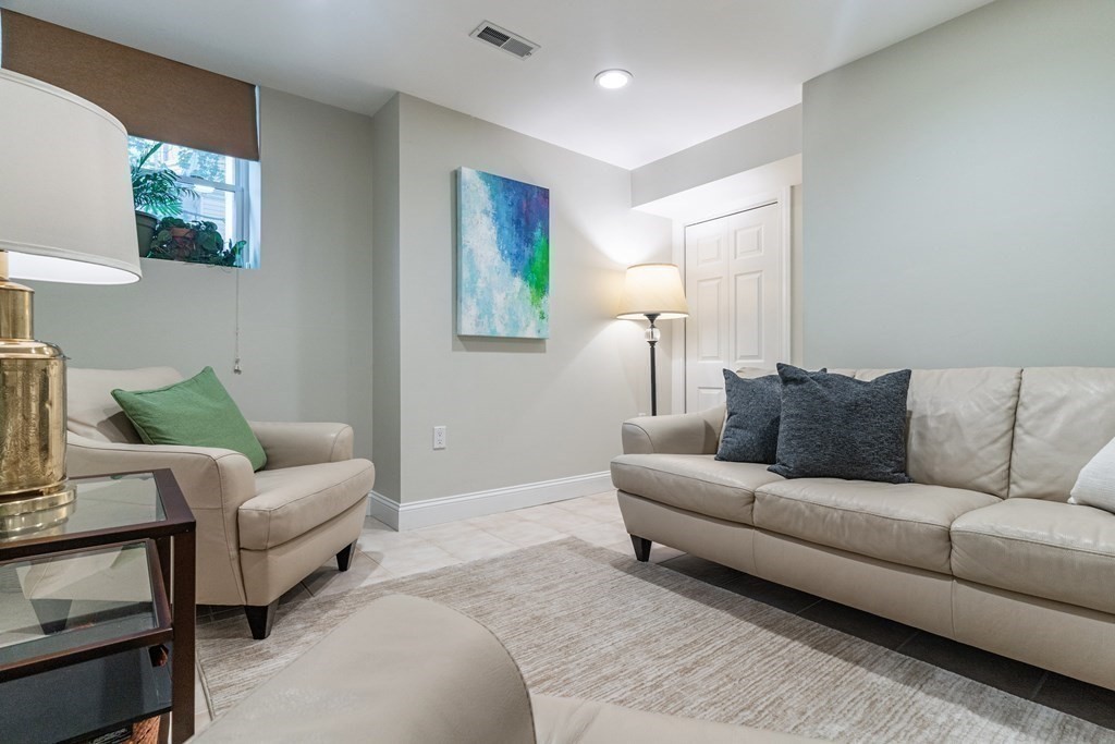 91 University Road, Unit 1 Brookline, MA 02445 - Photo 26 of 39 a living room with furniture and a couch