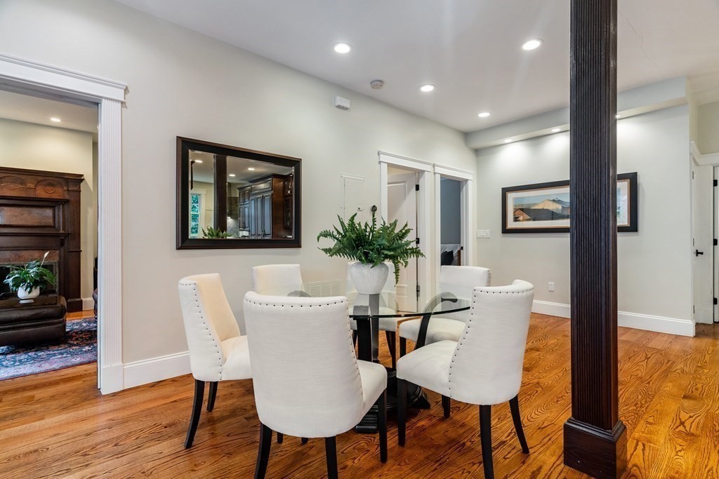 91 University Road, Unit 1 Brookline, MA 02445 - Photo 8 of 39 a view of a dining room with furniture and wooden floor