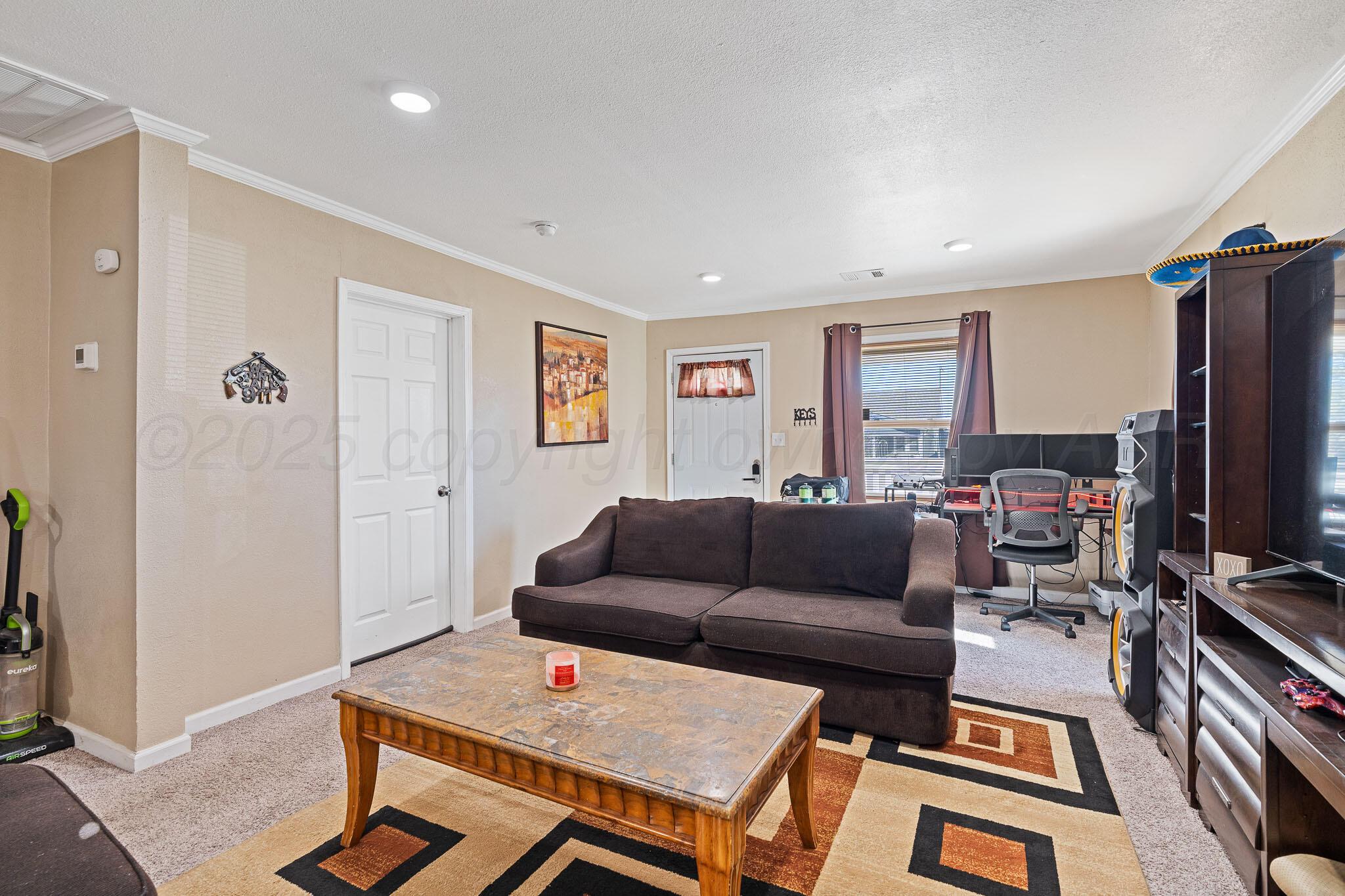 702 South Cleveland Street Amarillo, TX 79102 - Photo 4 of 11 a living room with furniture and a flat screen tv