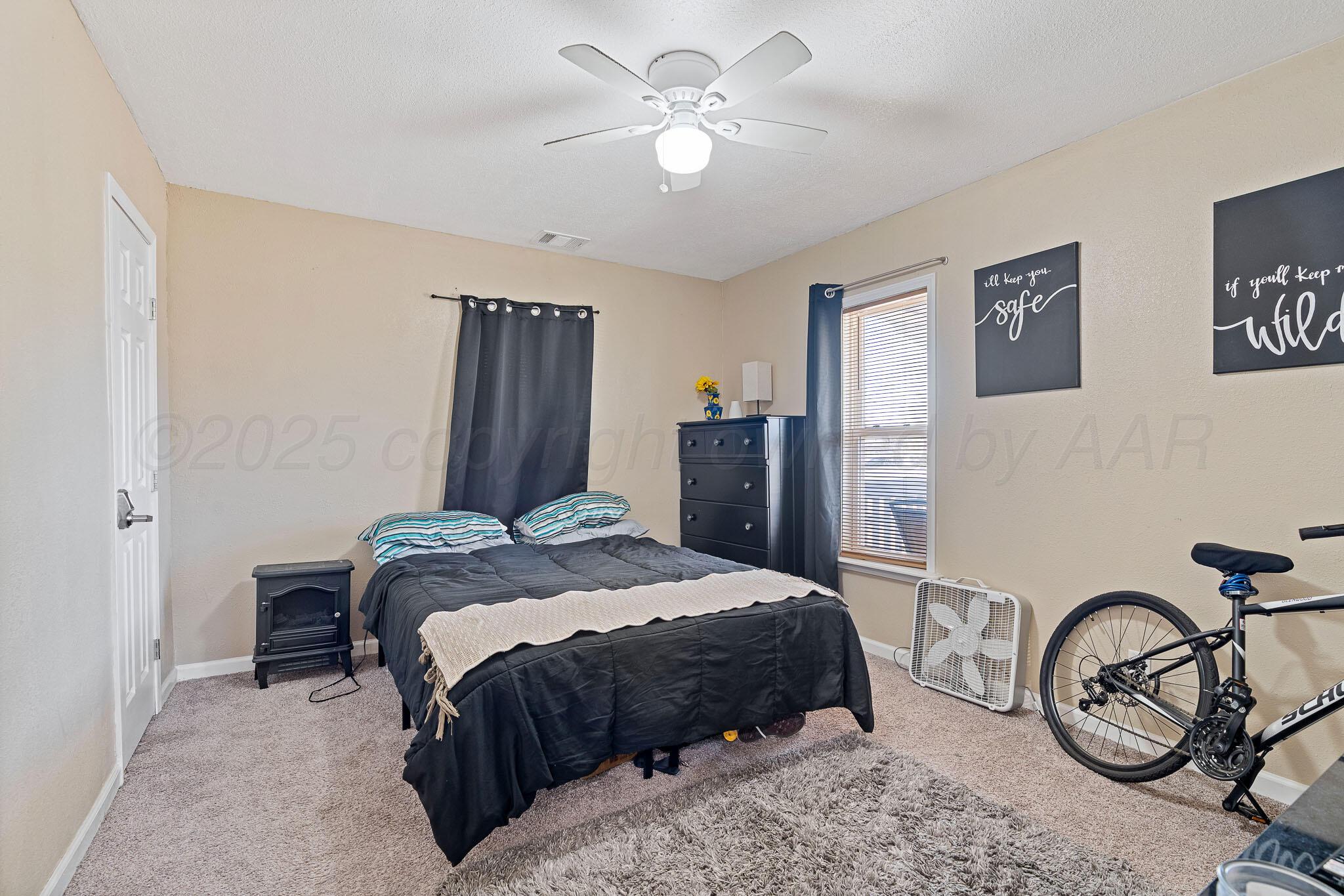 702 South Cleveland Street Amarillo, TX 79102 - Photo 7 of 11 a bedroom with a bed and a chandelier