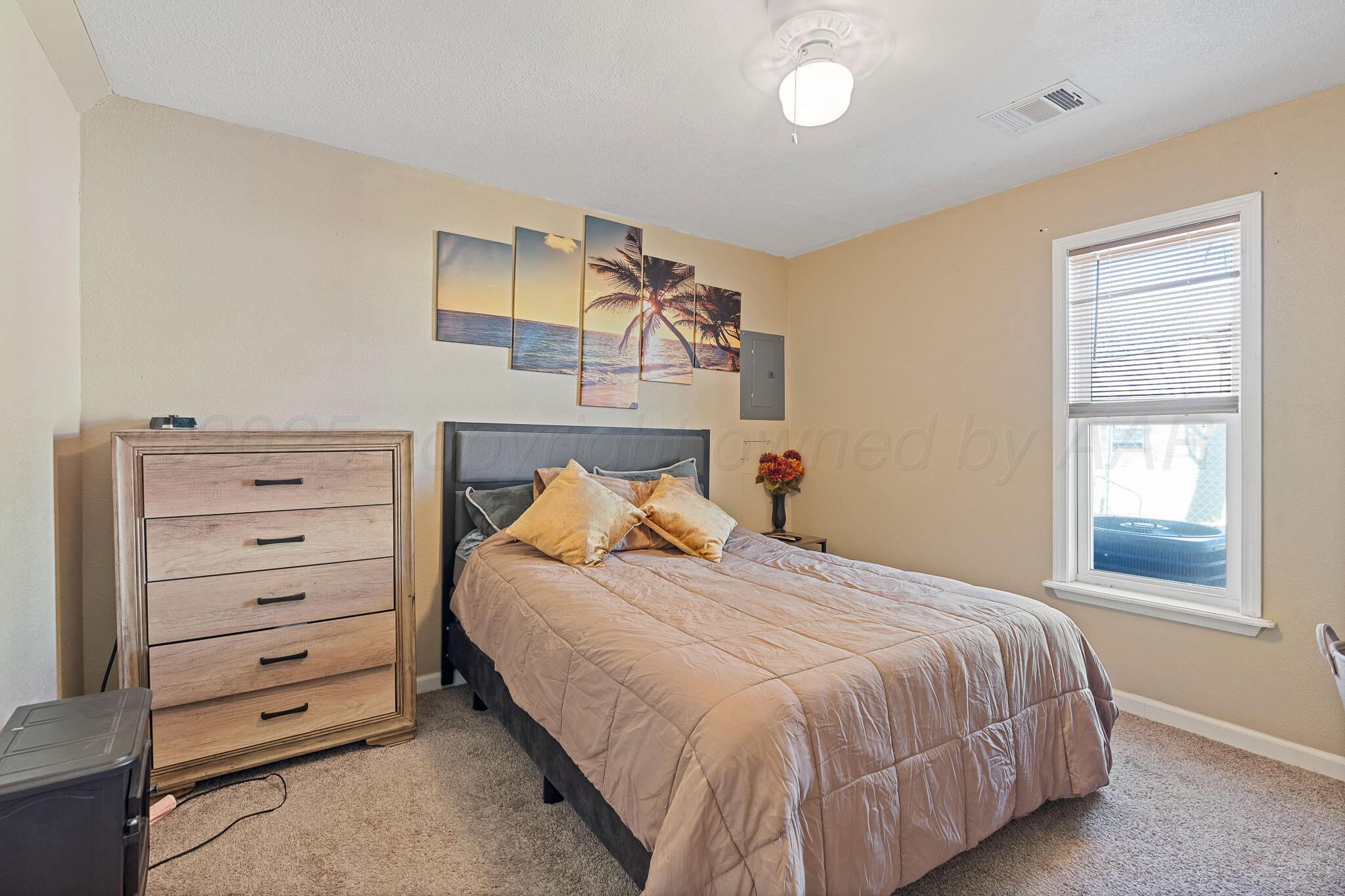 702 South Cleveland Street Amarillo, TX 79102 - Photo 9 of 11 a bedroom with a bed and a window