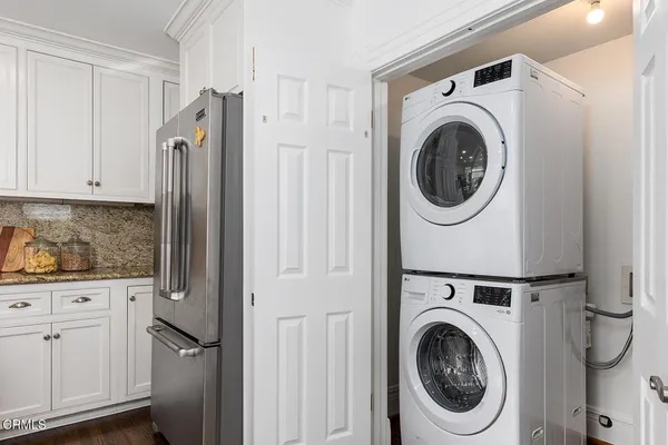 a bedroom with a bed and painting on the wall
