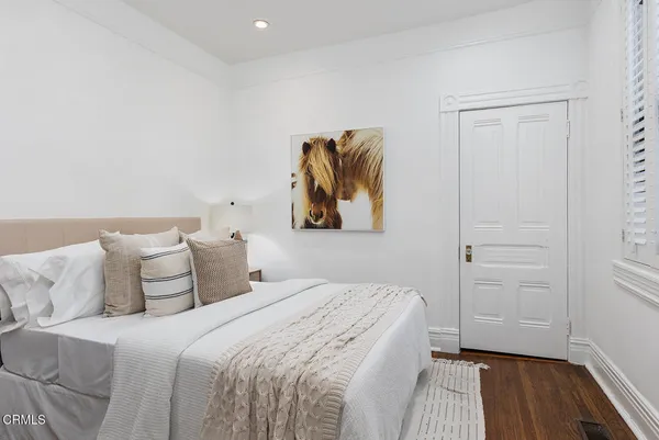 a bedroom with a bed and a book shelf