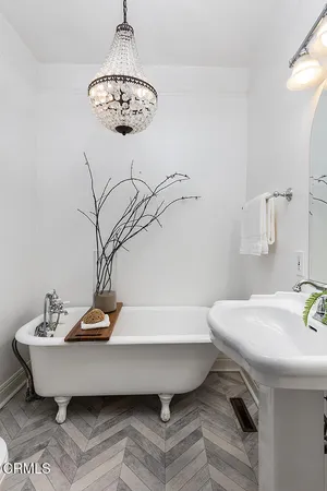 a view of a hallway with wooden floor and windows