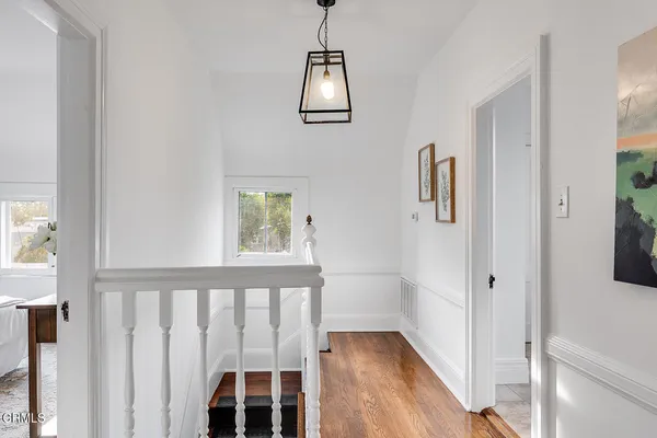 a bedroom with two beds and a dresser with mirror