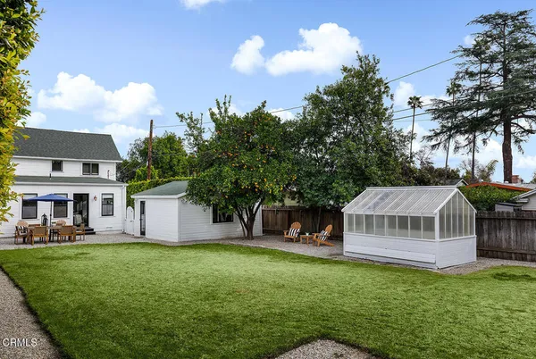 a view of a house with a yard and sitting area