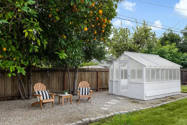 a view of a house with backyard porch and sitting area