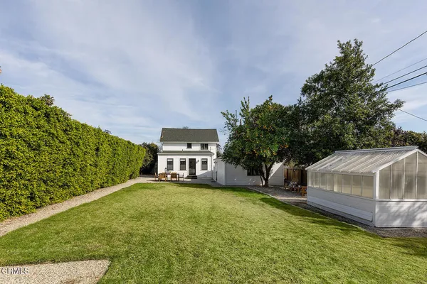 an aerial view of multiple houses with a yard