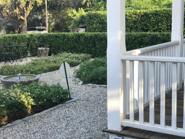 a view of a hallway with wooden floor and windows