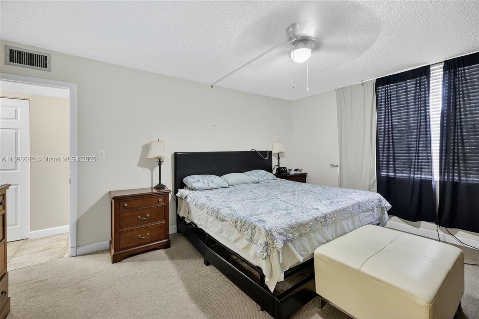 3821 Environ Boulevard, Unit 411 Lauderhill, FL 33319 - Photo 12 of 62 a bedroom with a bed and a chandelier
