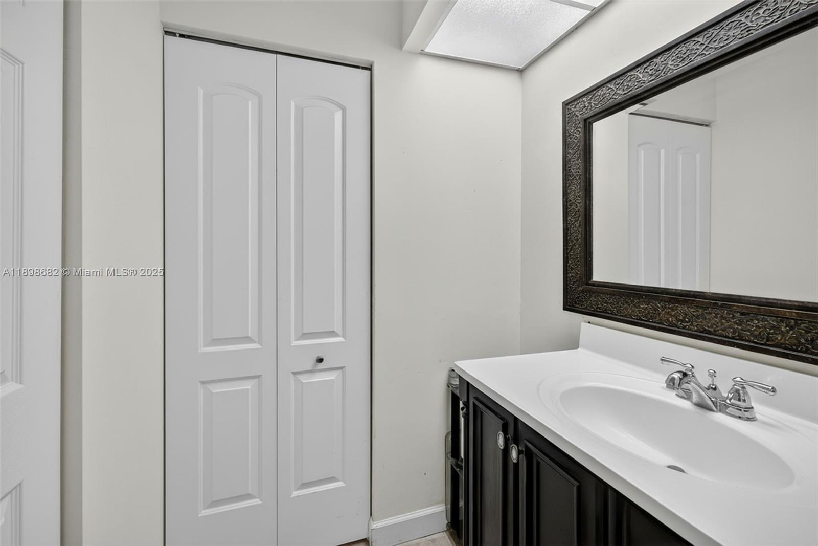 3821 Environ Boulevard, Unit 411 Lauderhill, FL 33319 - Photo 17 of 62 a bathroom with a sink and a mirror