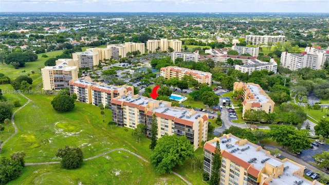 an aerial view of a house with a garden and lake view