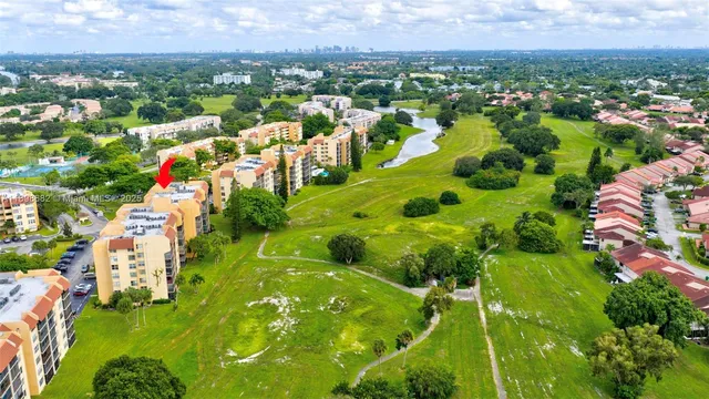 a row of palm trees sitting in a yard