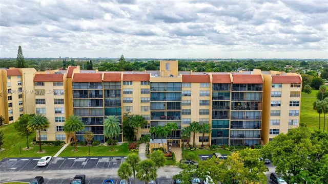 a view of a swimming pool with a patio and lake view