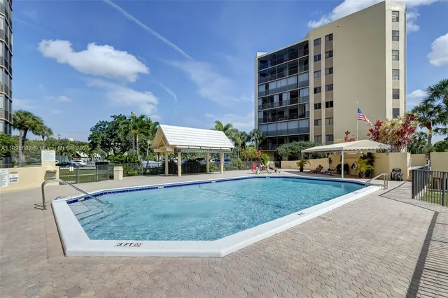 a living room with furniture pool table and chairs