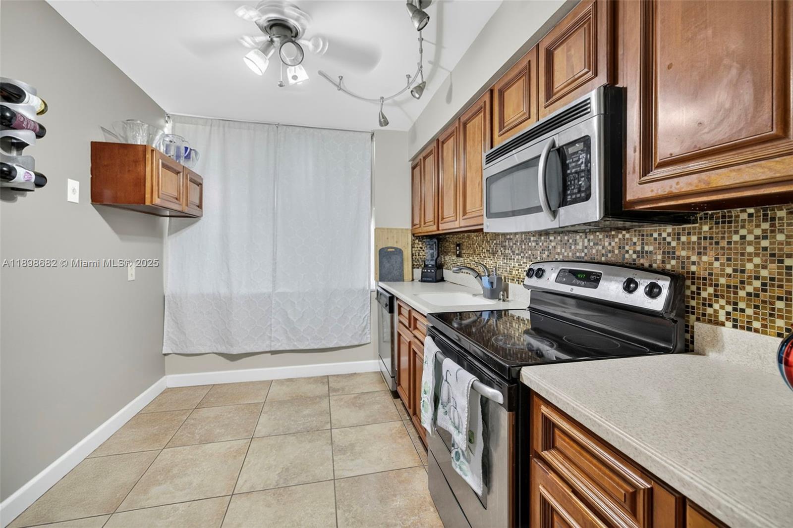 3821 Environ Boulevard, Unit 411 Lauderhill, FL 33319 - Photo 4 of 62 a kitchen with a stove and a sink