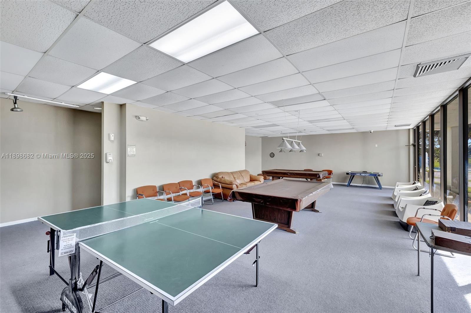 3821 Environ Boulevard, Unit 411 Lauderhill, FL 33319 - Photo 45 of 62 a living room with furniture pool table and chairs