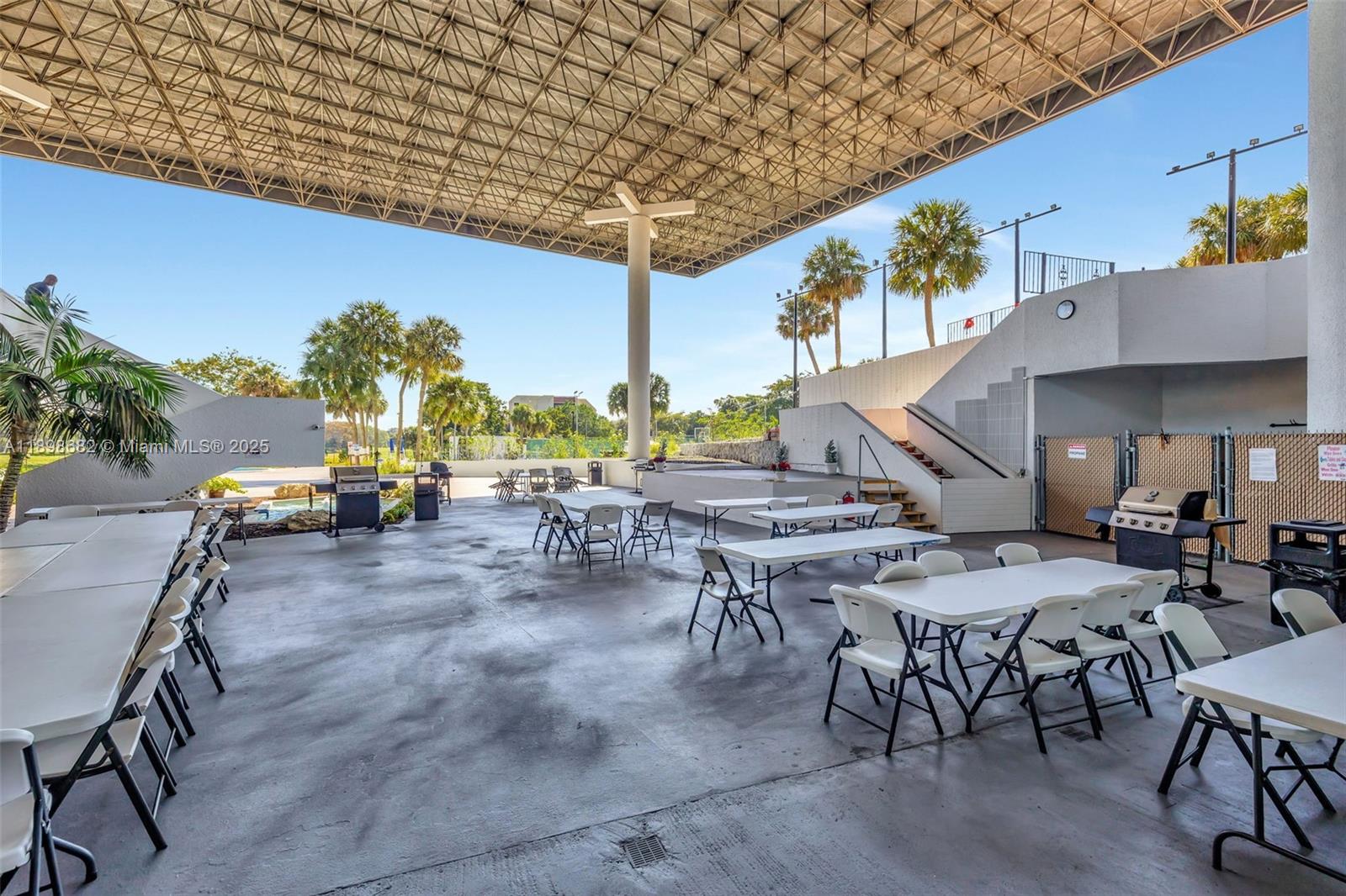 3821 Environ Boulevard, Unit 411 Lauderhill, FL 33319 - Photo 46 of 62 a view of a patio with a table and chairs