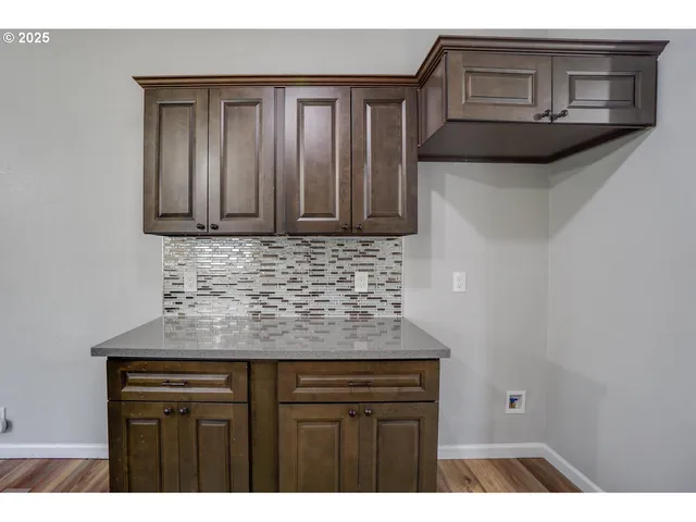 a kitchen with granite countertop a sink and cabinets