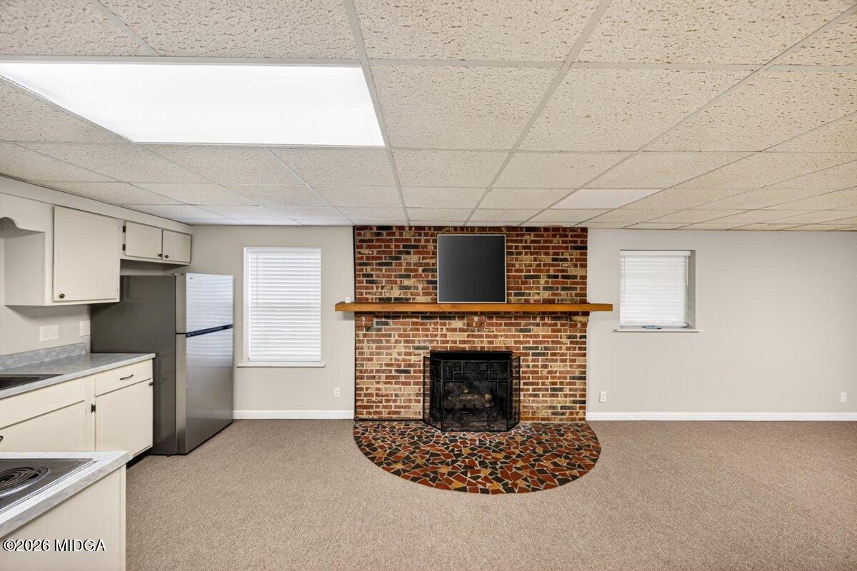 335 Hamrick Road Macon, GA 31220 - Photo 27 of 41 a living room with stainless steel appliances granite countertop a fireplace a stove top oven a sink and a refrigerator