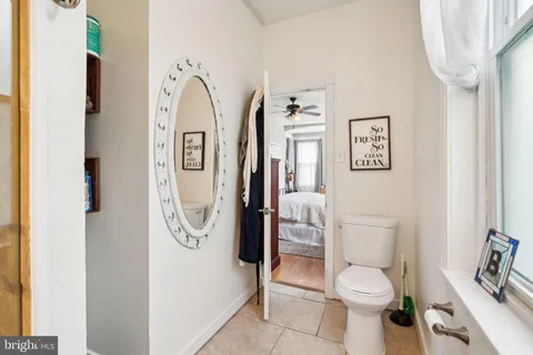 a white toilet sitting next to a bathroom sink