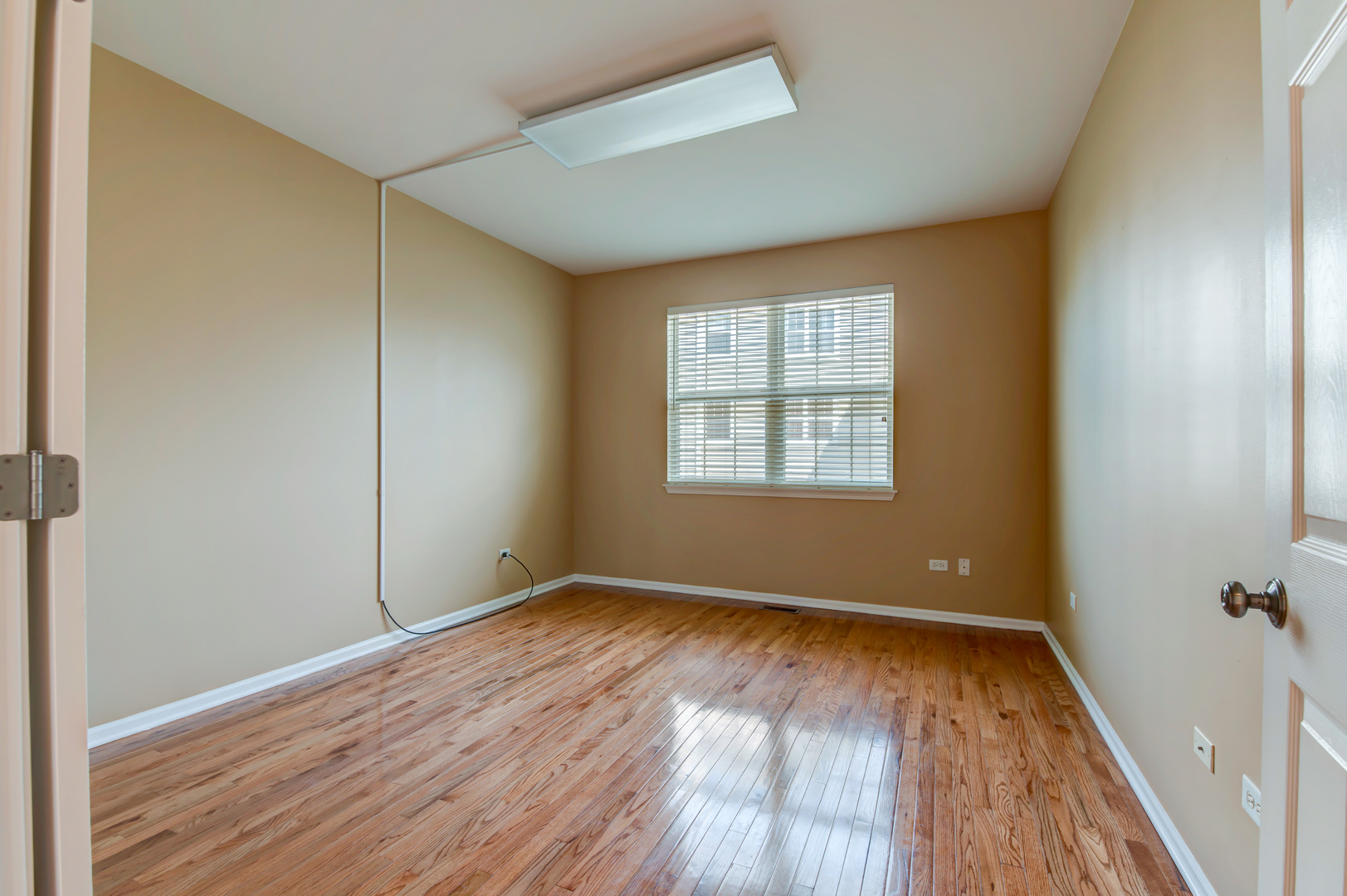 860 Spring Creek Circle Naperville, IL 60565 - Photo 13 of 26 an empty room with wooden floor and windows