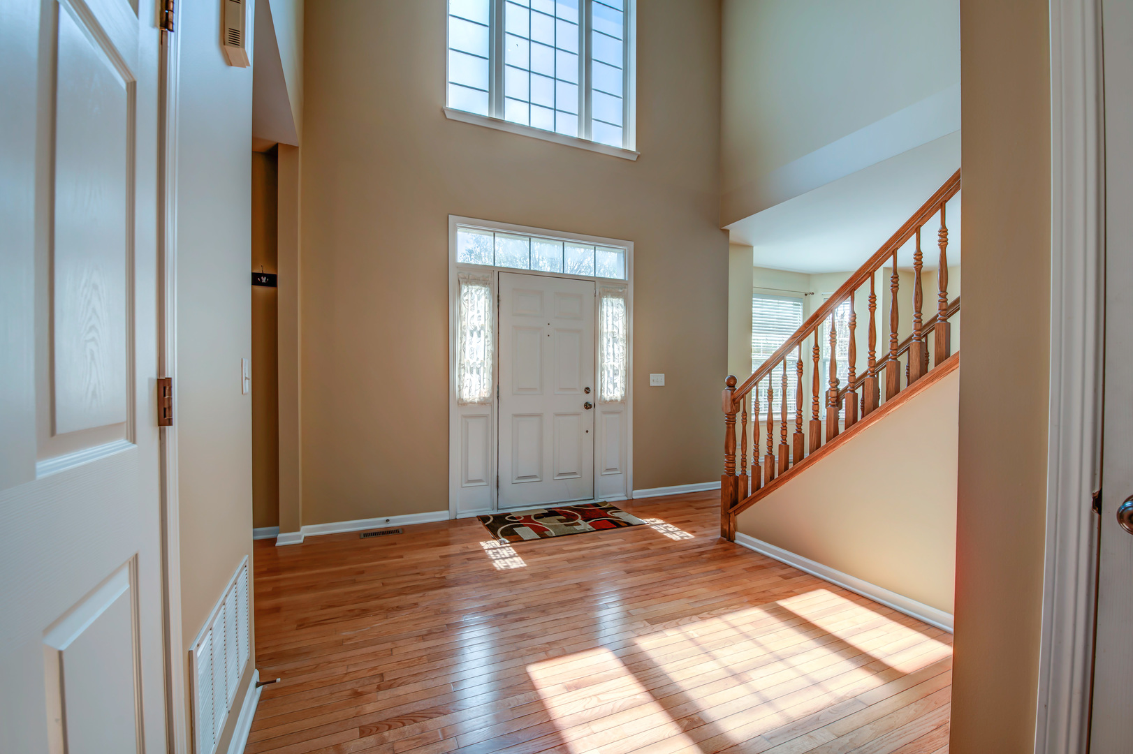 860 Spring Creek Circle Naperville, IL 60565 - Photo 3 of 26 a view of a hallway with wooden floor and staircase