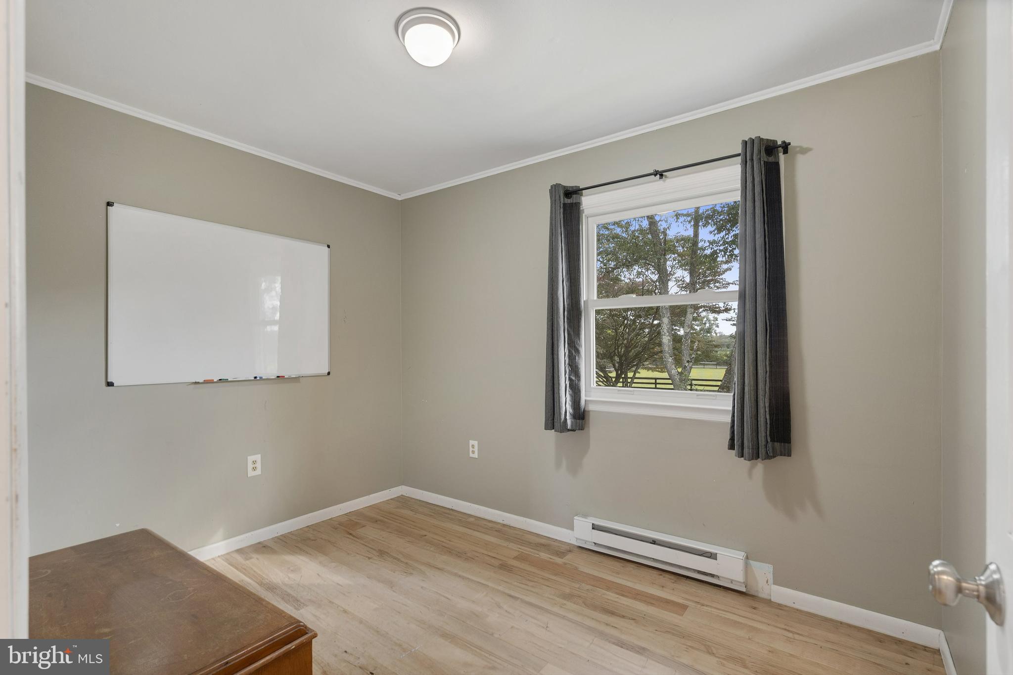 86 Bunting Bridge Road Cookstown, NJ 08511 - Photo 14 of 36 a view of an empty room with wooden floor and a window