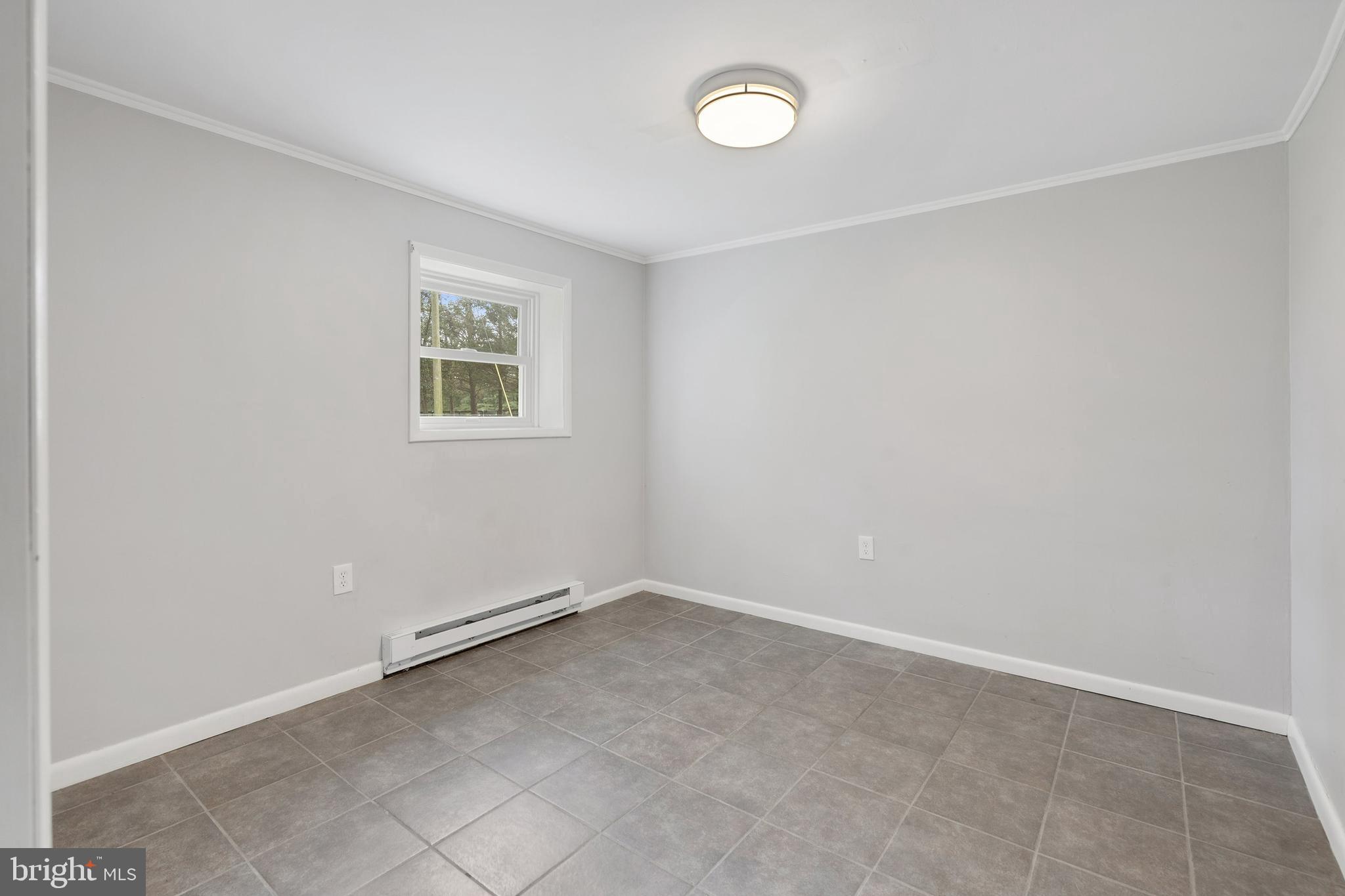 86 Bunting Bridge Road Cookstown, NJ 08511 - Photo 15 of 36 an empty room with a workbench