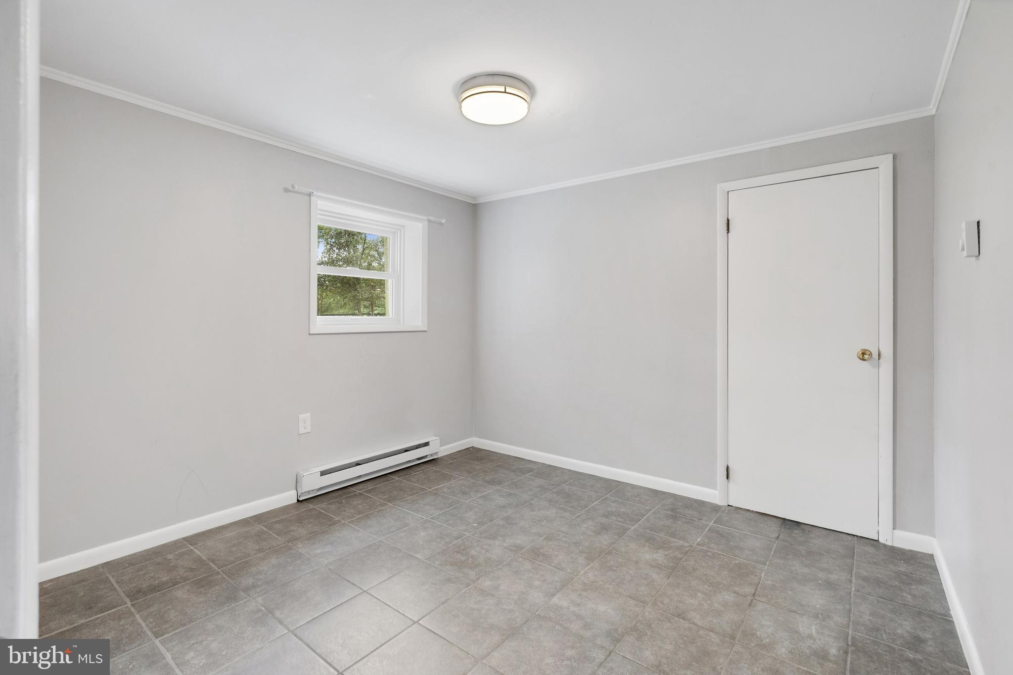 86 Bunting Bridge Road Cookstown, NJ 08511 - Photo 16 of 36 an empty room with a empty space and windows