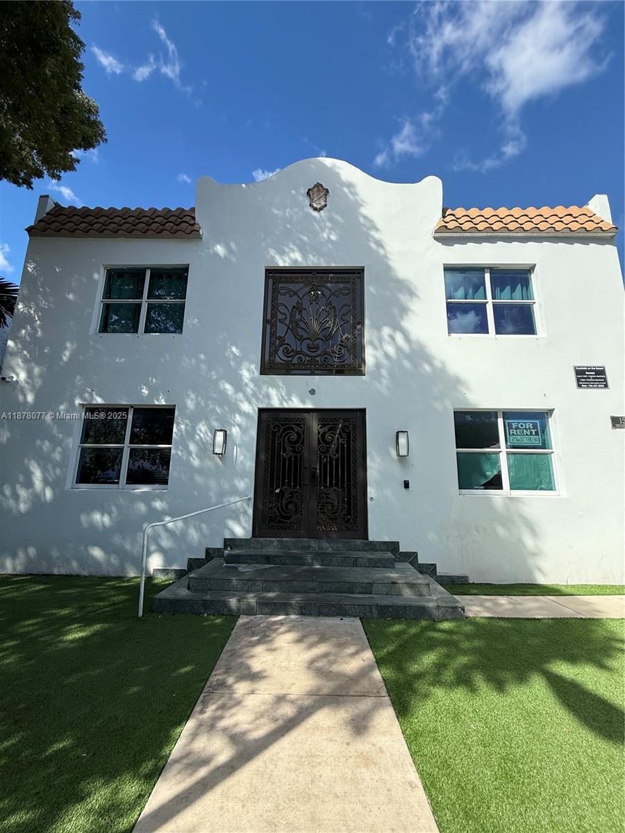 1560 Drexel Avenue, Unit 207 Miami Beach, FL 33139 - Photo 12 of 12 a front view of a house with a garden