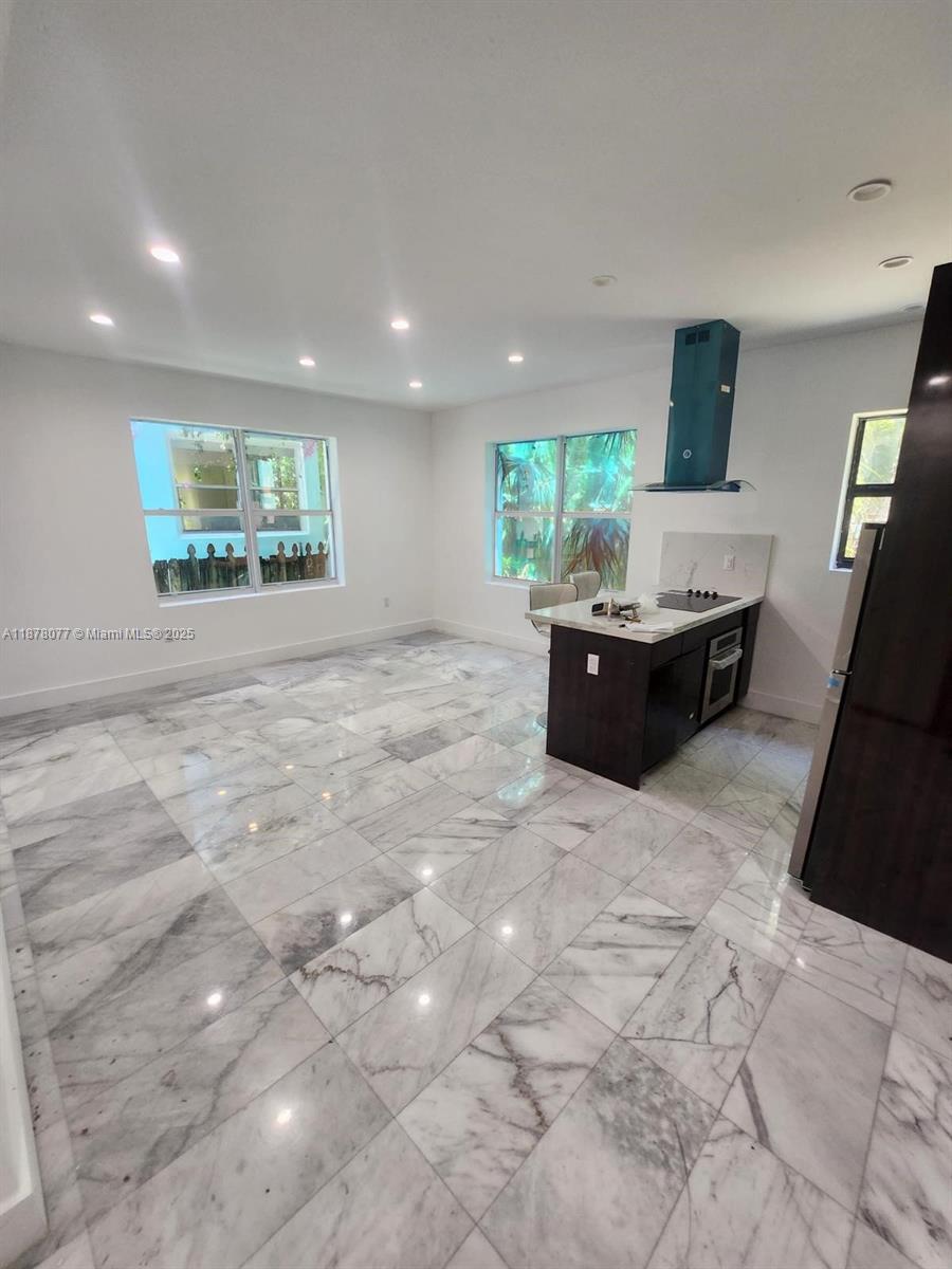 1560 Drexel Avenue, Unit 207 Miami Beach, FL 33139 - Photo 2 of 12 a living room with furniture and a large window