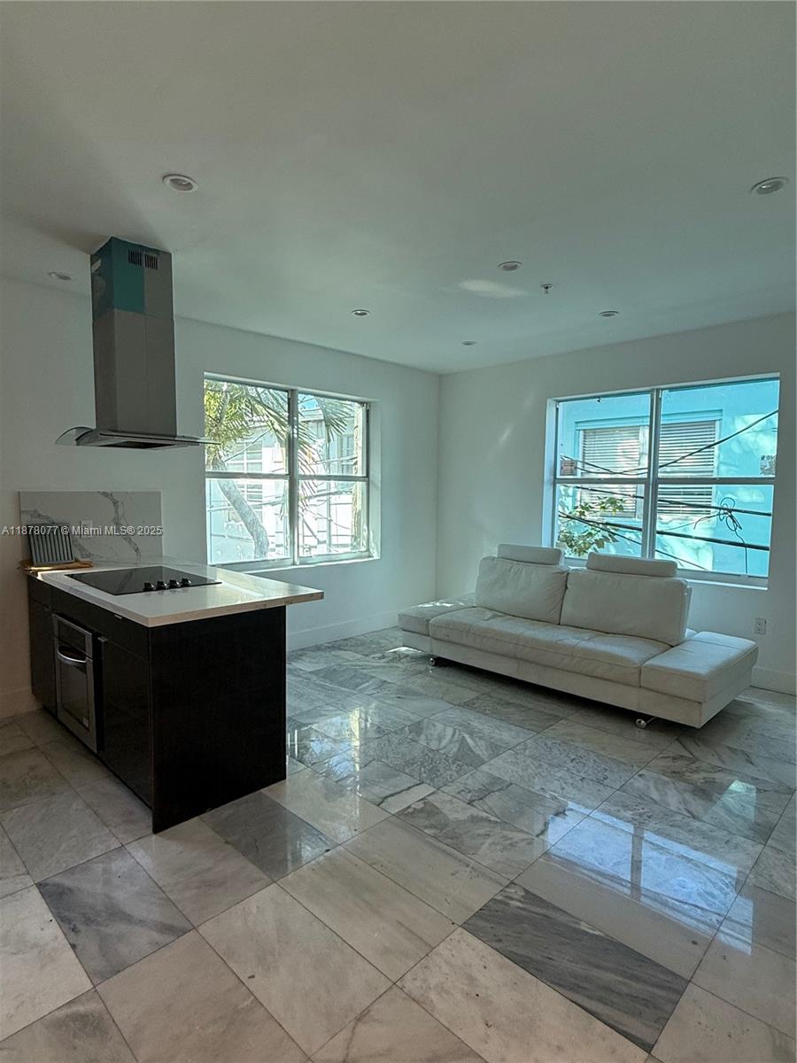 1560 Drexel Avenue, Unit 207 Miami Beach, FL 33139 - Photo 5 of 12 a living room with furniture and a large window