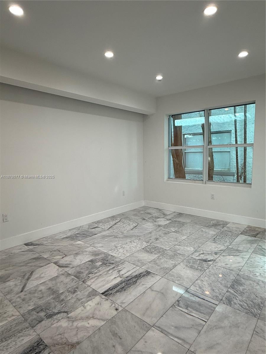 1560 Drexel Avenue, Unit 207 Miami Beach, FL 33139 - Photo 7 of 12 a view of an empty room with a window