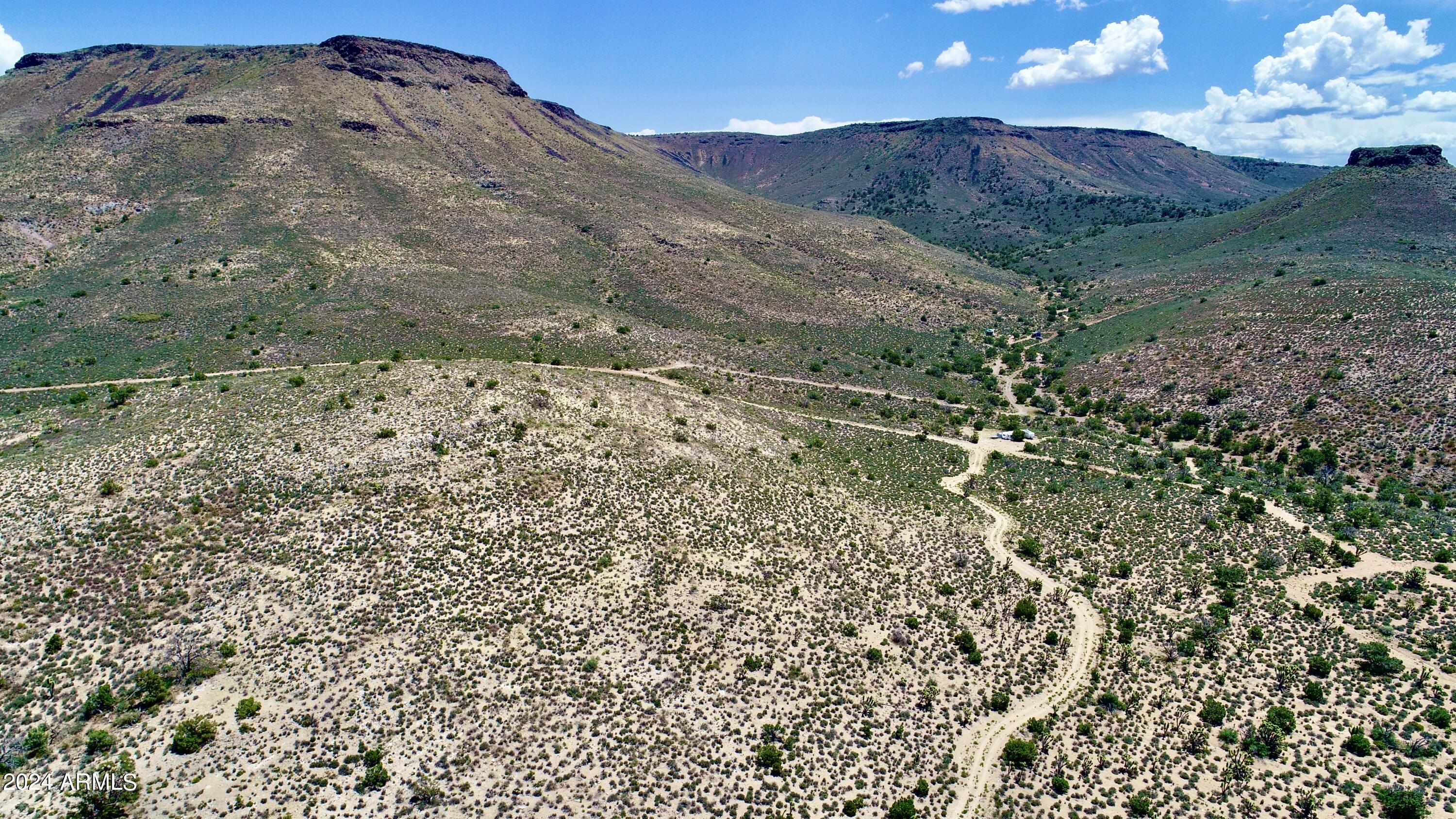 5838 East Diamond Bar Road Meadview, AZ 86444 - Photo 24 of 26 a view of a dry yard with mountains in the background