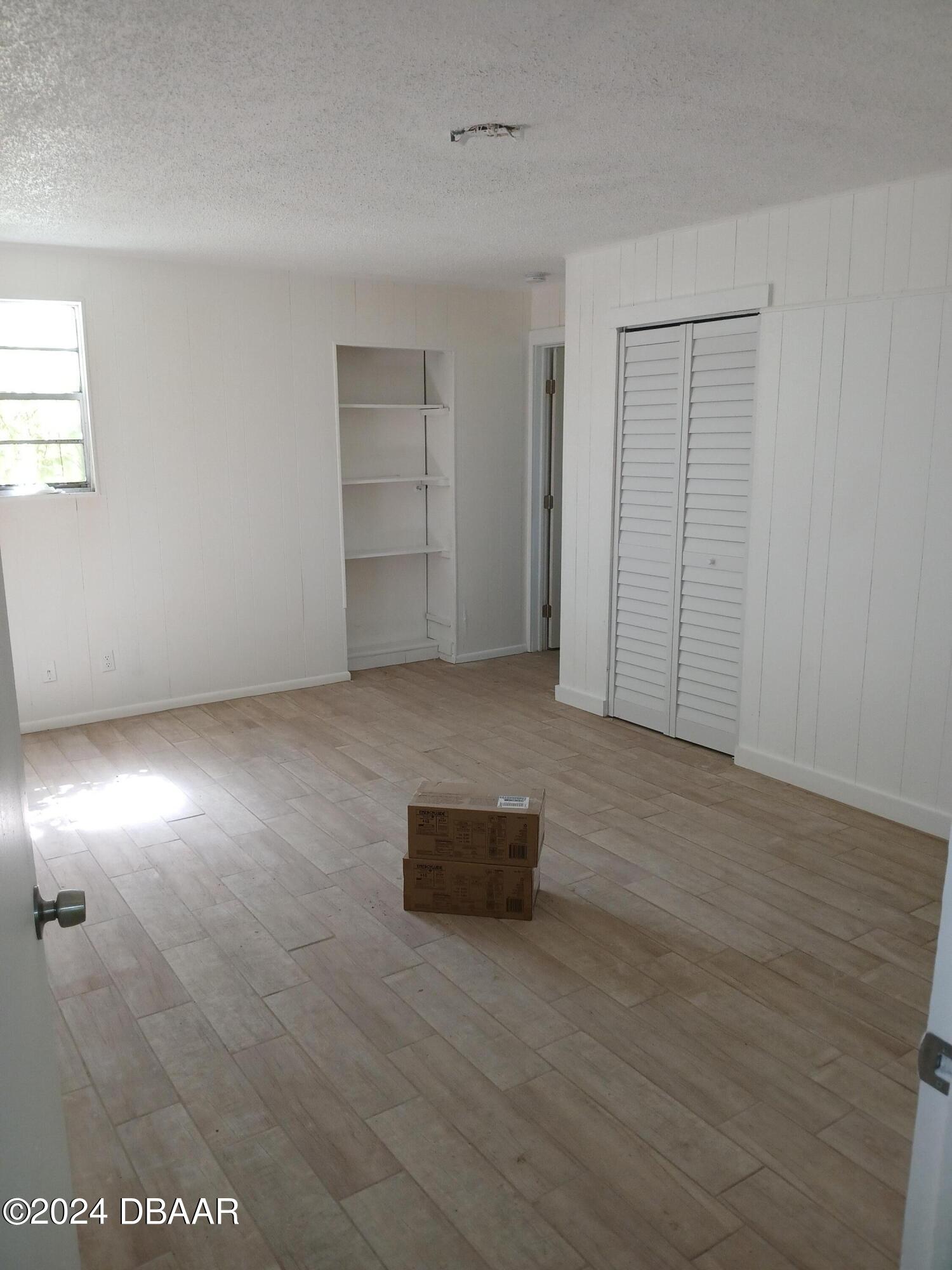 232 Summit Street Crescent City, FL 32112 - Photo 3 of 12 an empty room with wooden floor and windows