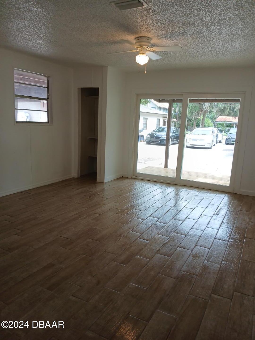 232 Summit Street Crescent City, FL 32112 - Photo 4 of 12 an empty room with wooden floor and windows